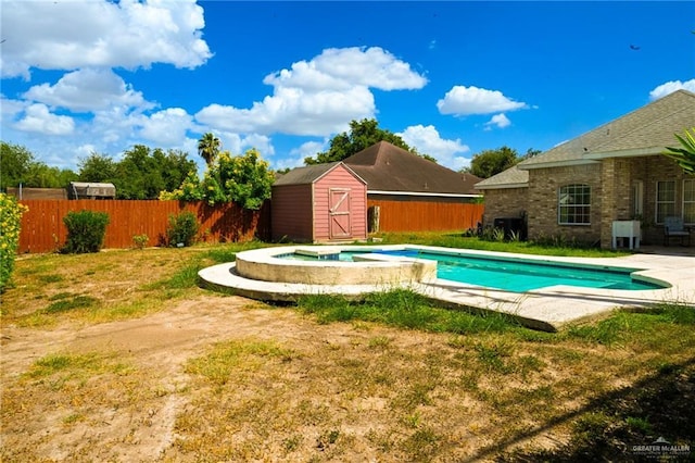 view of pool featuring an in ground hot tub, a yard, and a storage shed