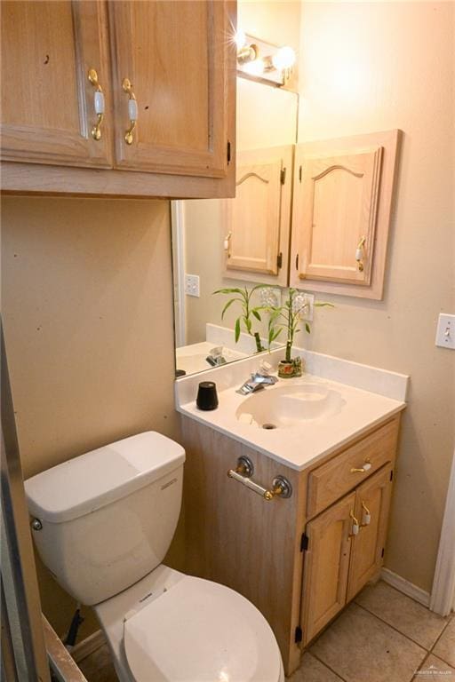 bathroom featuring toilet, vanity, and tile patterned floors