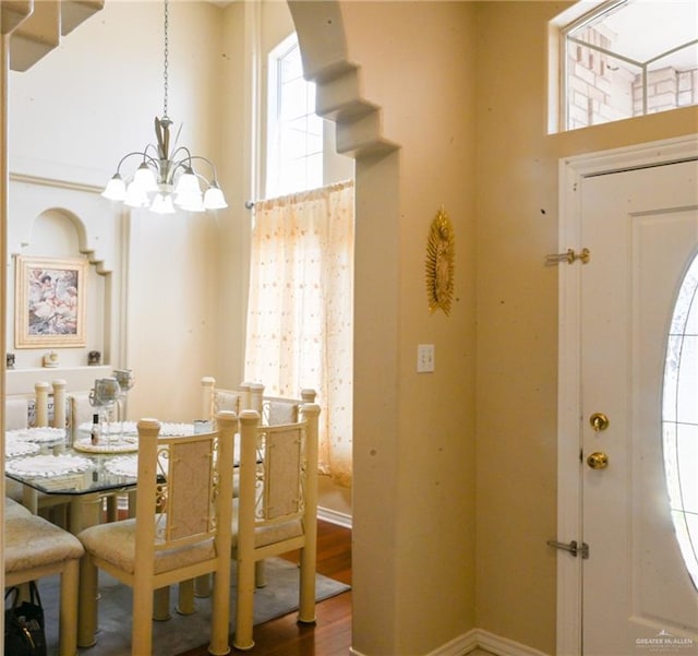 dining space featuring a chandelier and wood-type flooring