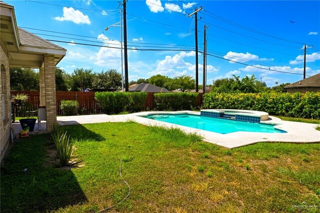 view of pool with a lawn and an in ground hot tub