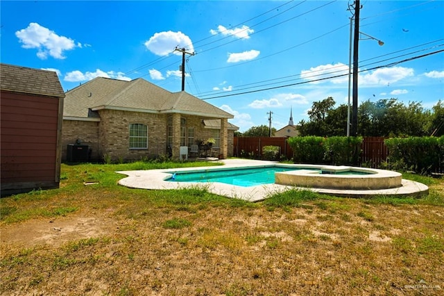 view of swimming pool featuring central air condition unit, an in ground hot tub, a yard, and a shed