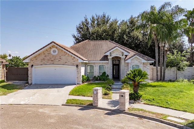 mediterranean / spanish-style home with a front yard and a garage