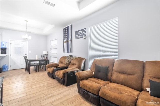 3301 S Colt Ln, Edinburg, TX 78539 - living room with a raised ceiling, a chandelier, and light wood finished floors