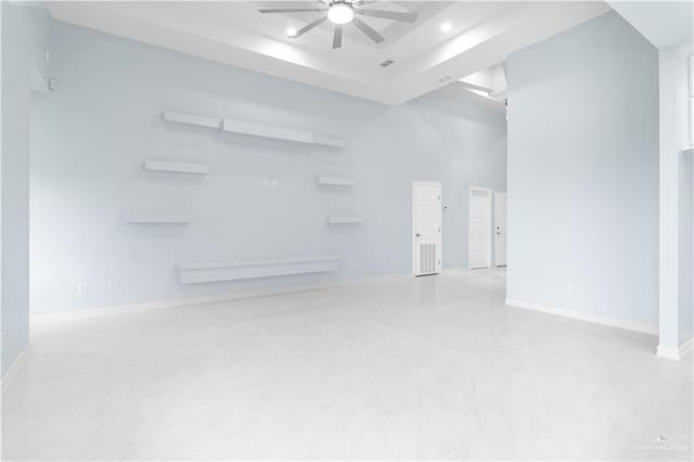 spare room with baseboards, a raised ceiling, recessed lighting, and ceiling fan