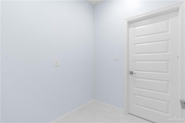 empty room featuring baseboards and marble finish floor