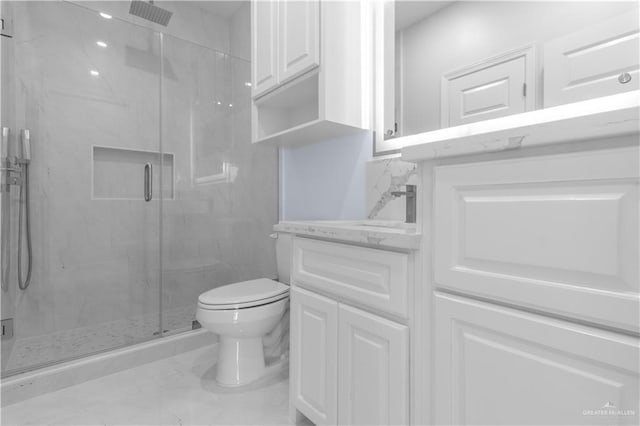 full bath with toilet, a marble finish shower, marble finish floor, and vanity