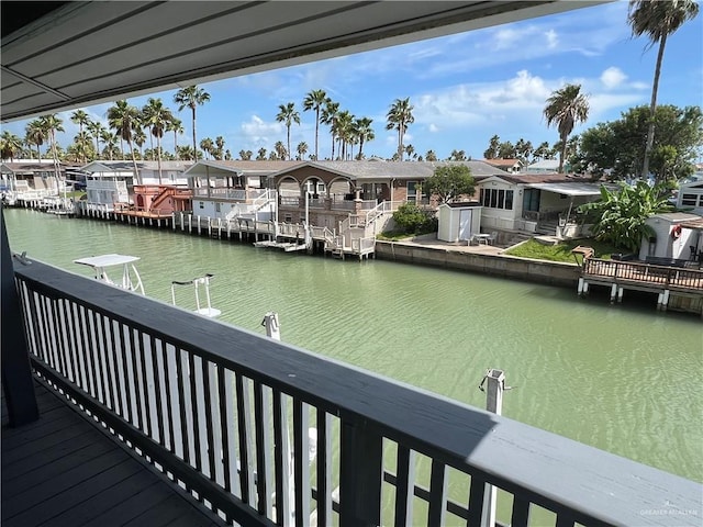 view of dock with a residential view and a water view