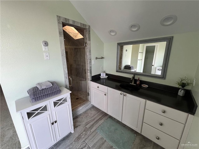 full bath featuring lofted ceiling, a shower stall, and vanity