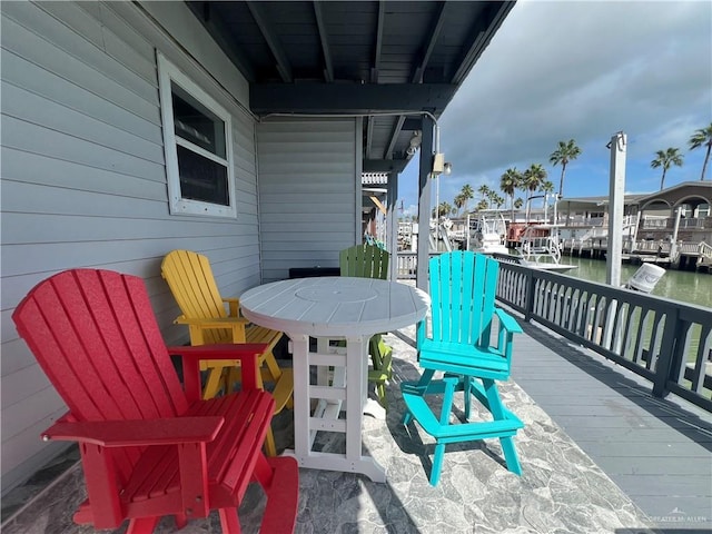 exterior space with a water view and a dock