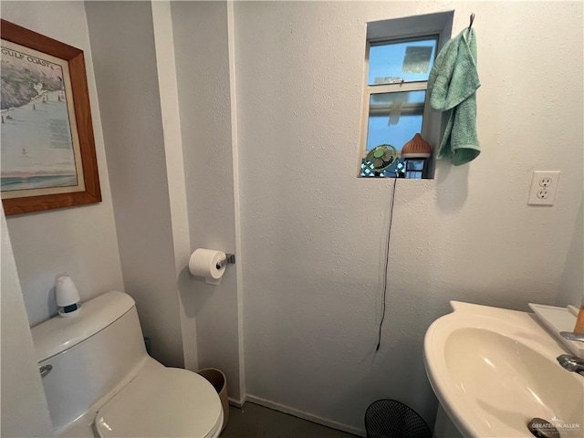 bathroom with toilet and a sink