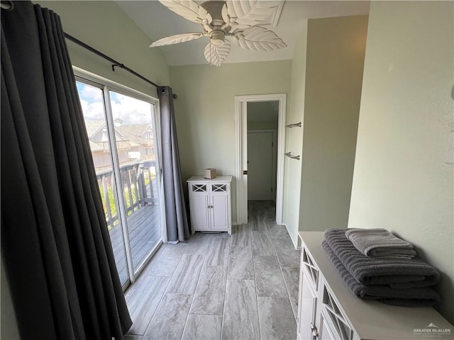 interior space featuring white cabinets, a ceiling fan, and light countertops