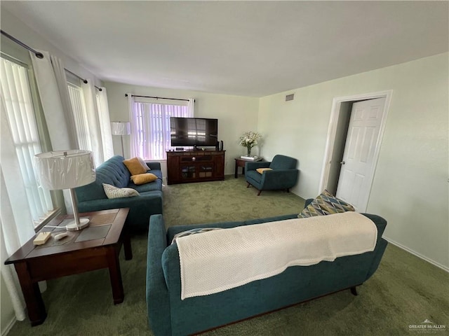 carpeted living area featuring visible vents