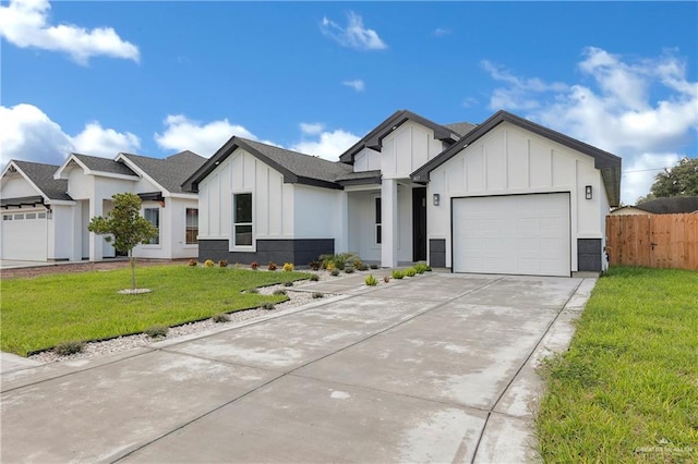 modern farmhouse featuring a garage and a front lawn