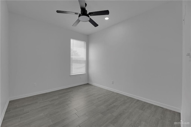 empty room with ceiling fan and light wood-type flooring