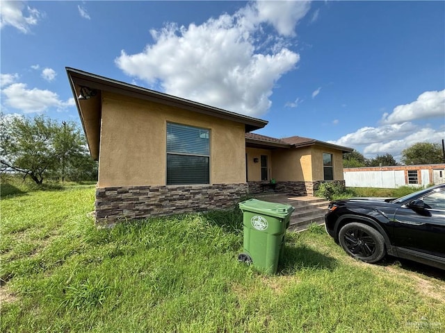 view of property exterior with a yard