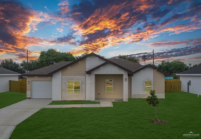 ranch-style home featuring a lawn and a garage