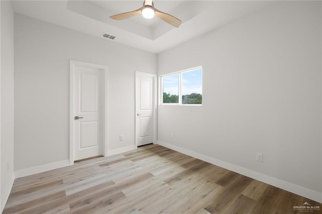 2615 E Solar Dr, Mission, TX 78574 - unfurnished bedroom featuring a raised ceiling, light wood finished floors, and a ceiling fan