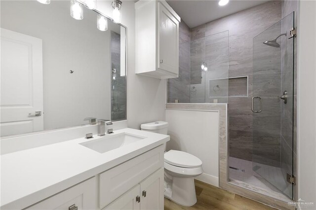 2615 E Solar Dr, Mission, TX 78574 - full bathroom featuring a stall shower, vanity, wood finished floors, and recessed lighting