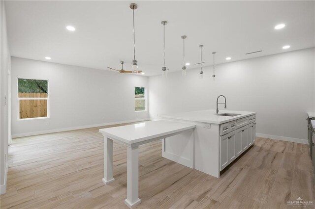 2615 E Solar Dr, Mission, TX 78574 - kitchen with light wood-type flooring, hanging light fixtures, open floor plan, recessed lighting, and light countertops