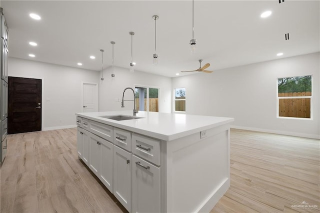 2615 E Solar Dr, Mission, TX 78574 - kitchen featuring light wood finished floors, recessed lighting, a kitchen island with sink, ceiling fan, and light countertops