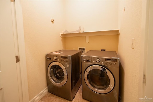 laundry room featuring independent washer and dryer and light tile patterned floors