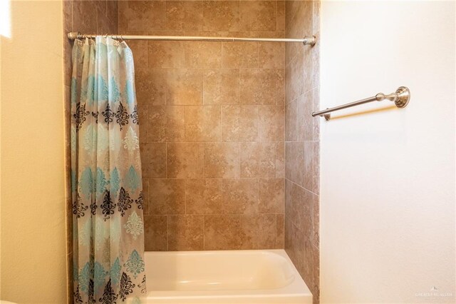 bathroom with shower / tub combo with curtain