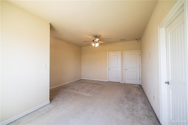 unfurnished room featuring light carpet and ceiling fan