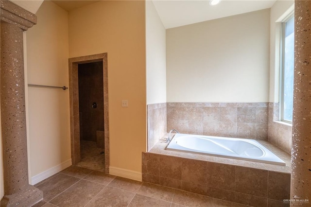 bathroom with tile patterned floors and plus walk in shower