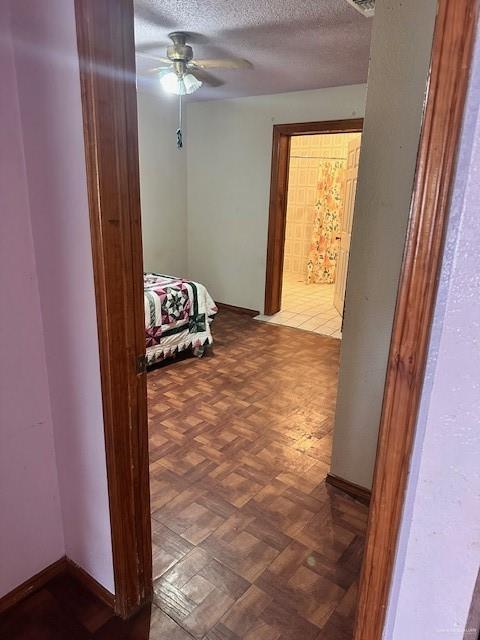 hall with parquet floors and a textured ceiling