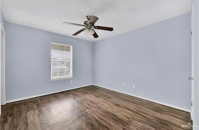 empty room featuring a textured ceiling, dark hardwood / wood-style floors, and ceiling fan