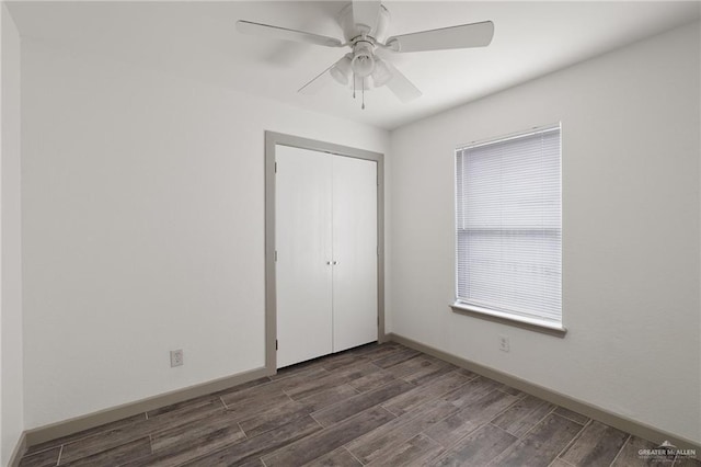 2120 Grambling Ave, Mcallen, TX 78504 - unfurnished bedroom with dark wood-style floors, a closet, baseboards, and a ceiling fan