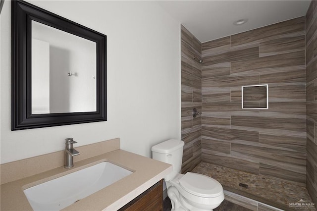 2120 Grambling Ave, Mcallen, TX 78504 - full bathroom with vanity, a tile shower, and toilet