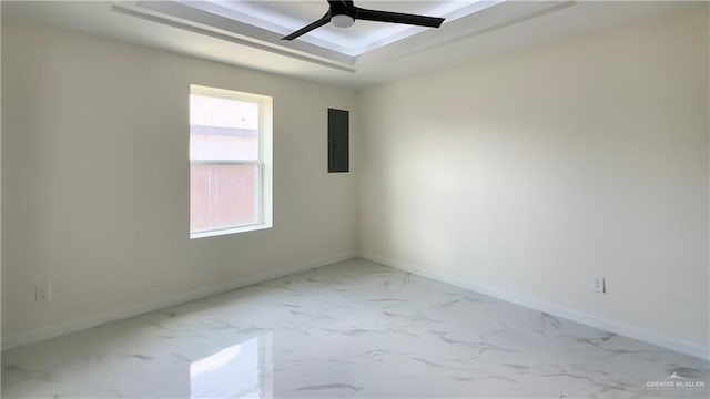 unfurnished room with a ceiling fan, marble finish floor, electric panel, and baseboards