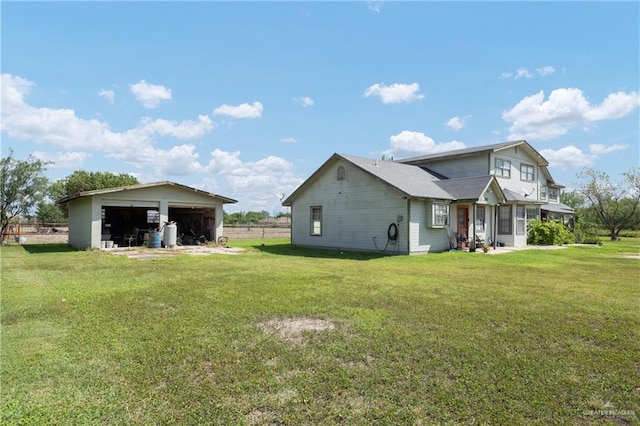 view of property exterior featuring a lawn, a garage, and an outbuilding