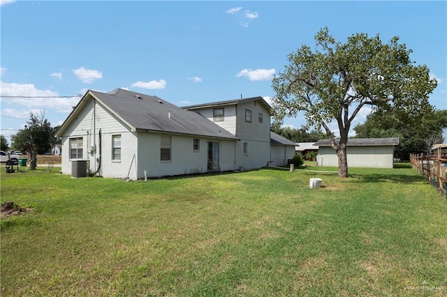 back of house featuring a yard and cooling unit