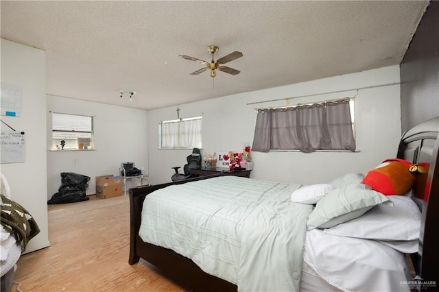 bedroom featuring a textured ceiling, hardwood / wood-style flooring, and ceiling fan