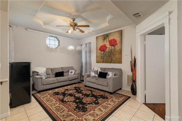 10766 N Minnesota Rd, Mission, TX 78574 - living area featuring light tile patterned floors, a tray ceiling, and a ceiling fan