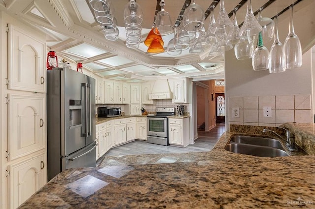 10766 N Minnesota Rd, Mission, TX 78574 - kitchen featuring stainless steel appliances, a sink, coffered ceiling, backsplash, and crown molding