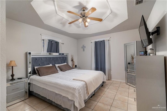 10766 N Minnesota Rd, Mission, TX 78574 - bedroom featuring light tile patterned flooring, a raised ceiling, and a ceiling fan