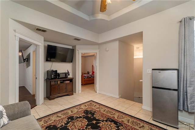 10766 N Minnesota Rd, Mission, TX 78574 - living room with light tile patterned flooring, a raised ceiling, and baseboards
