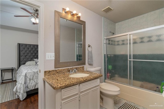 10766 N Minnesota Rd, Mission, TX 78574 - bathroom with connected bathroom, vanity, toilet, ceiling fan, and shower / bath combination with glass door