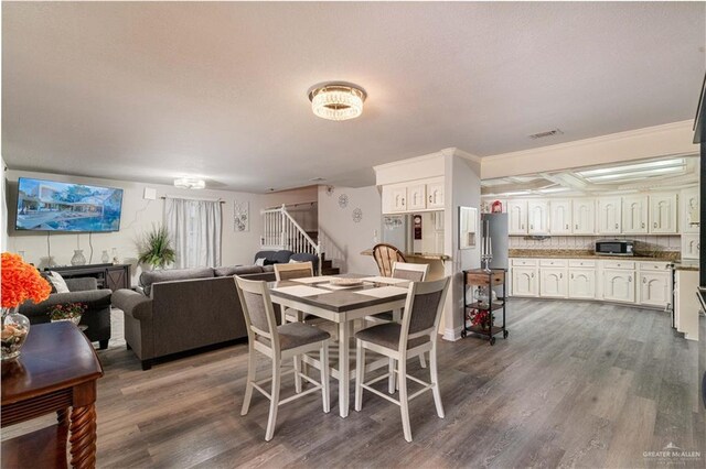 10766 N Minnesota Rd, Mission, TX 78574 - dining space with stairway and dark wood-type flooring