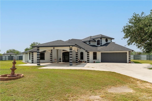 10766 N Minnesota Rd, Mission, TX 78574 - view of front of house featuring an attached garage, concrete driveway, and stucco siding