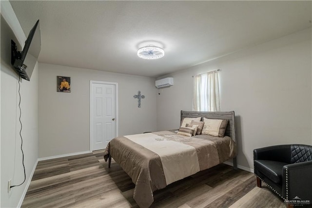 10766 N Minnesota Rd, Mission, TX 78574 - bedroom with wood finished floors, baseboards, and a wall unit AC