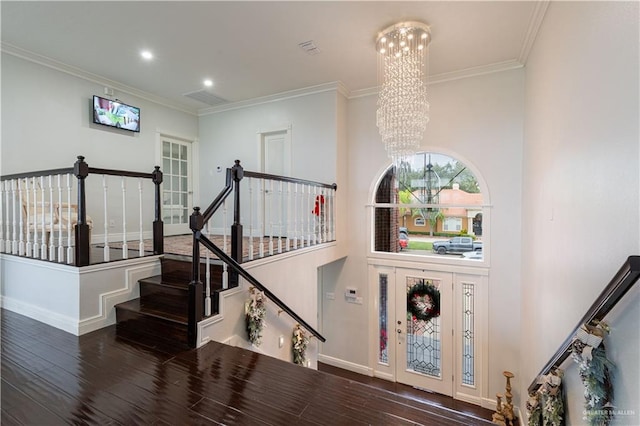 staircase featuring hardwood / wood-style floors, a chandelier, and ornamental molding