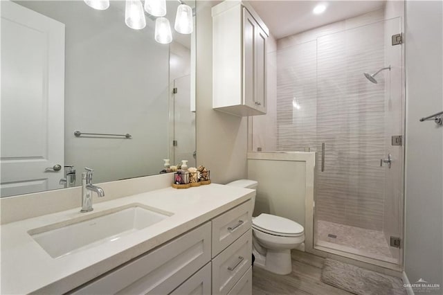 2509 Viola St, Mission, TX 78574 - bathroom featuring a shower stall, toilet, vanity, wood finished floors, and recessed lighting
