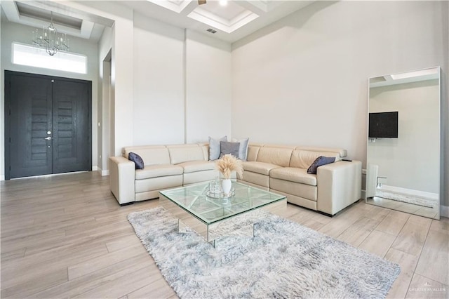 2509 Viola St, Mission, TX 78574 - living area with a high ceiling, coffered ceiling, light wood-type flooring, beamed ceiling, and baseboards