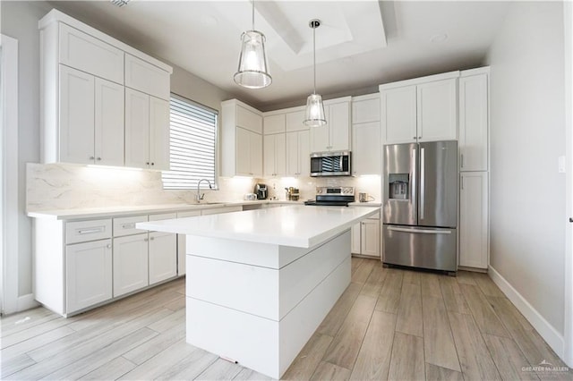 2509 Viola St, Mission, TX 78574 - kitchen with appliances with stainless steel finishes, decorative backsplash, a sink, light wood finished floors, and light countertops
