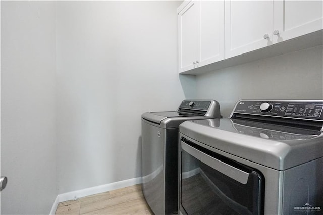 2509 Viola St, Mission, TX 78574 - laundry room featuring cabinet space, washer and dryer, light wood-style floors, and baseboards