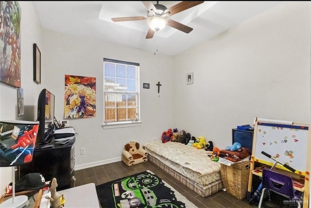 bedroom featuring ceiling fan, baseboards, and wood tiled floor